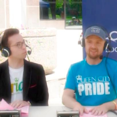 Phil of Curtis Paradis (left) and Phil Ollenberg (right) co-hosting the 2015 Queen City Pride Festival TV broadcast produced by Access Communications